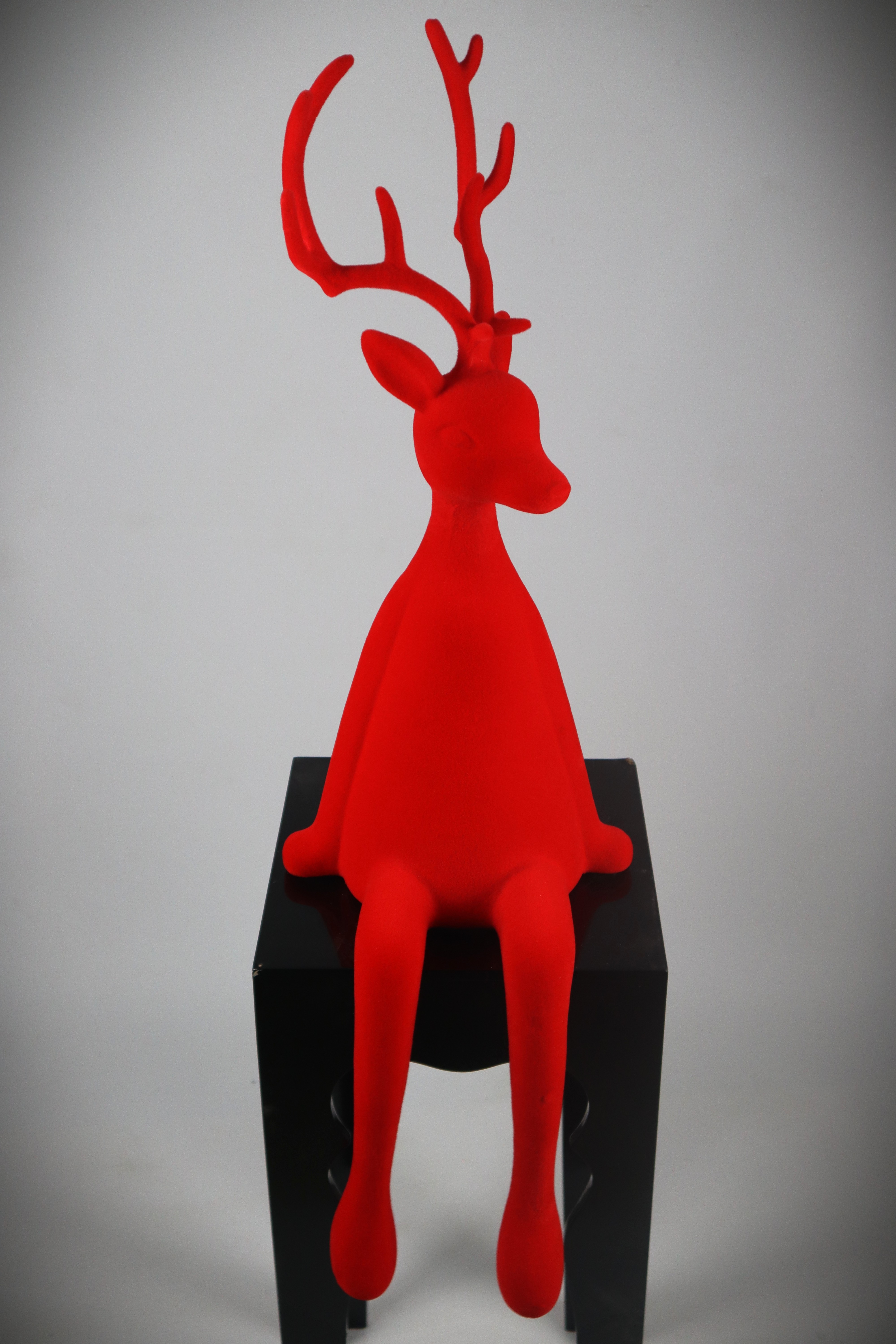 Rentier sitzend rot - Flock Kunstst. 93cm